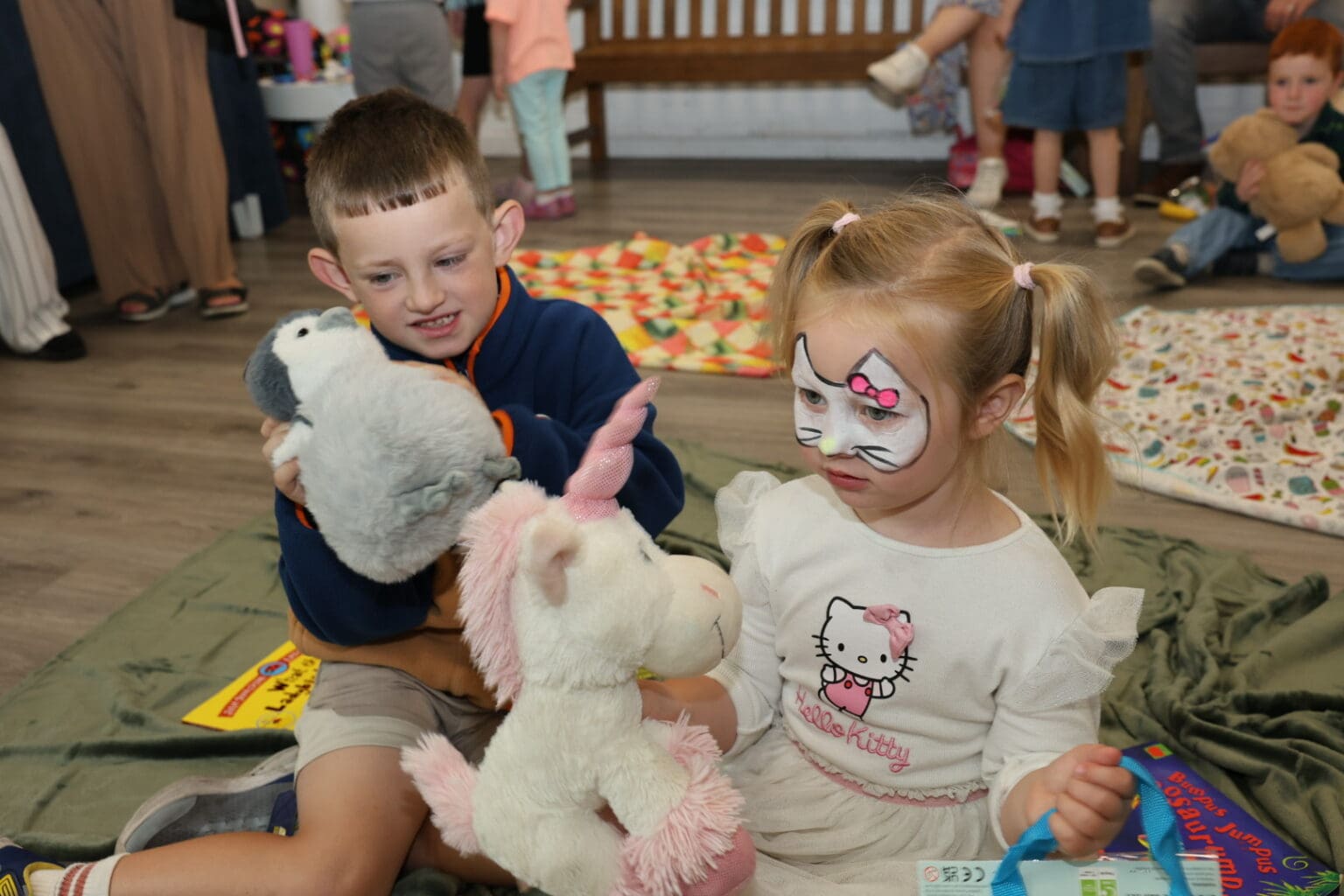 Two children with face paint holding soft toys at The Wellness Event at Crescent Shopping Centre.