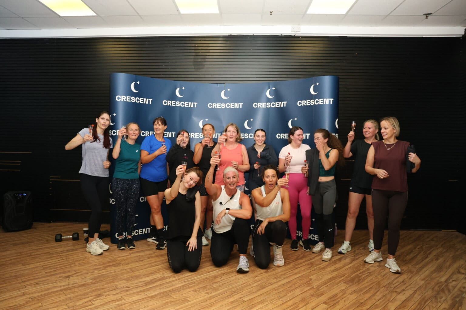 A large group of instructors and participants together at the end of The Wellness Event at Crescent Shopping Centre.